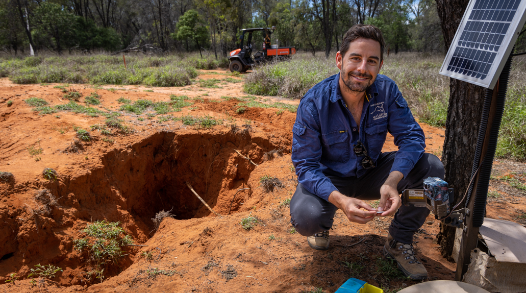 Ecologist Andy How near a Hairy-nosed Wombat burrow on Richard Underwood Nature Refuge