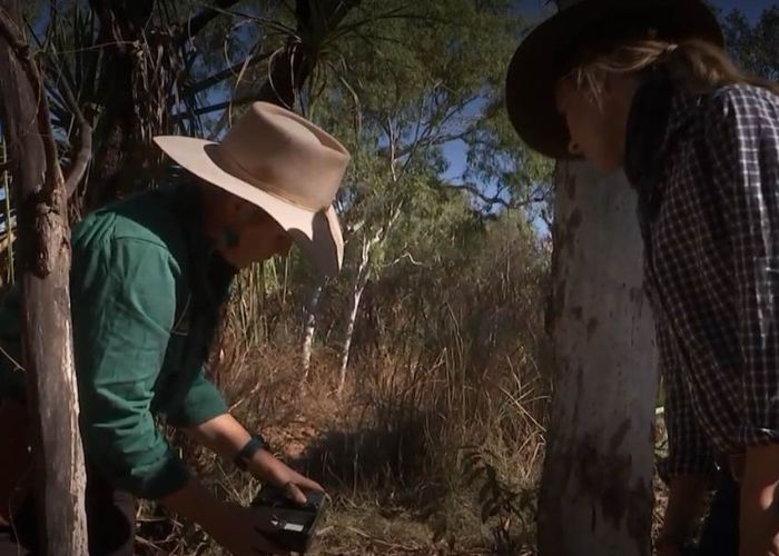 Dr Eridani Mulder, AWC Senior Wildlife Ecologist, checks a camera trap with Landline Kristy O'Brien. 